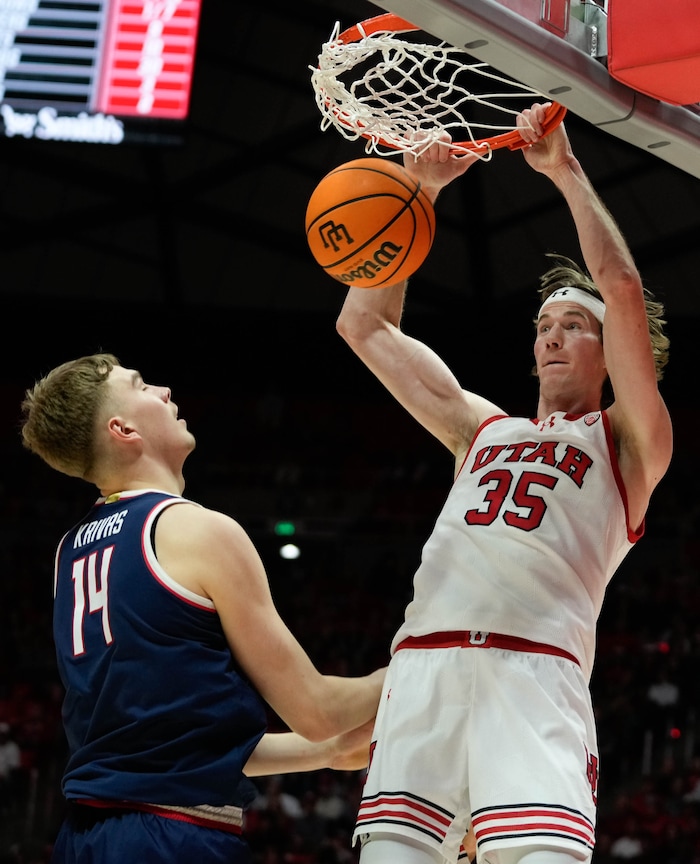 (Francisco Kjolseth  |  The Salt Lake Tribune) Utah Utes center Branden Carlson (35) dunks in front of Arizona Wildcats center Motiejus Krivas (14) in PAC-12 basketball action between the Utah Utes and the Arizona Wildcats at the Jon M. Huntsman Center, on Thursday, Feb. 8, 2024.