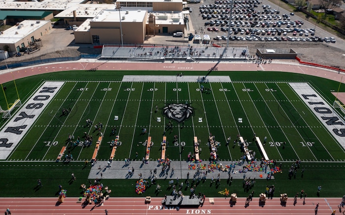 (Bethany Baker  |  The Salt Lake Tribune) Students and volunteers pack resource kits for Kevin Bacon’s nonprofit SixDegrees at a charity event to commemorate the 40th anniversary of the movie “Footloose” on the football field of Payson High School in Payson on Saturday, April 20, 2024.