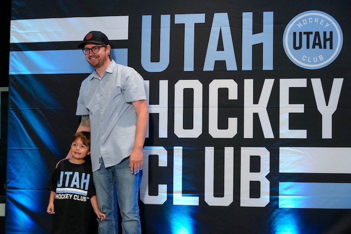 (Francisco Kjolseth  |  The Salt Lake Tribune) Garrett Stone and his son Levi, 4, pose for a picture as they attend the NHL draft party at the Delta Center in Salt Lake City on Friday, June 28, 2024.