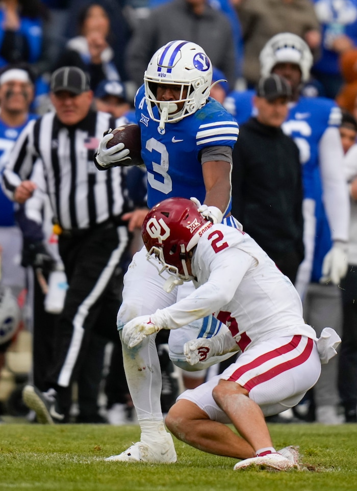 (Bethany Baker  |  The Salt Lake Tribune) Brigham Young Cougars running back Aidan Robbins (3) runs the ball as Oklahoma Sooners defensive back Billy Bowman Jr. (2) defends at LaVell Edwards Stadium in Provo on Saturday, Nov. 18, 2023.