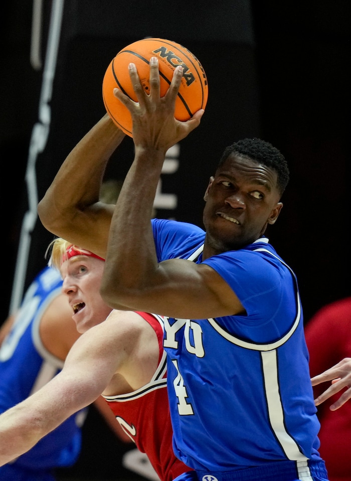 (Bethany Baker  |  The Salt Lake Tribune) Brigham Young Cougars forward Atiki Ally Atiki (4) catches a rebound against the Utah Utes at the Jon M. Huntsman Center in Salt Lake City on Saturday, Dec. 9, 2023.