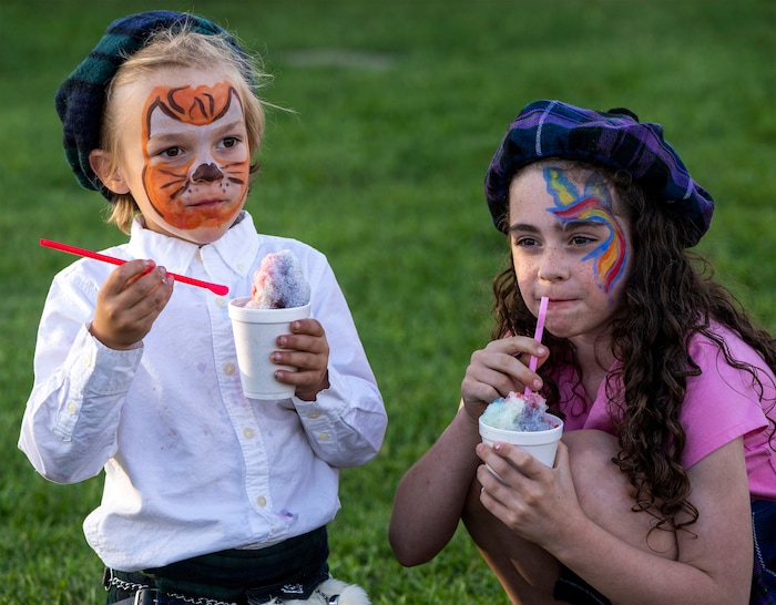 (Rick Egan | The Salt Lake Tribune) 
Lincoln and Penny Smith enjoy a treat at the Scottish Festival at the Utah Scottish Festival, at the Utah State Fairpark, on Friday, June 16, 2023.
