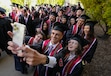 (Francisco Kjolseth  |  The Salt Lake Tribune) Chance Herd poses for a selfie with fellow graduates from the College of Architecture and Planning, capturing the moment before the convocation ceremonies commence on the University of Utah campus on Thursday, May 2, 2024. For fall 2024, enrollment grew at every college and university in the state.