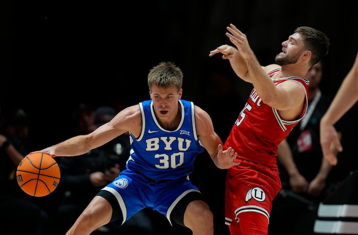 (Bethany Baker  |  The Salt Lake Tribune) Brigham Young Cougars guard Dallin Hall (30) is defended by Utah Utes guard Rollie Worster (25) at the Jon M. Huntsman Center in Salt Lake City on Saturday, Dec. 9, 2023.