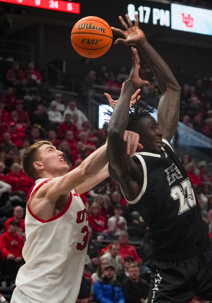 (Bethany Baker  |  The Salt Lake Tribune) Utah Utes center Lawson Lovering (34) and Hawaii Warriors center Mor Seck (23) fight for a rebound at the Delta Center in Salt Lake City on Thursday, Nov. 30, 2023.