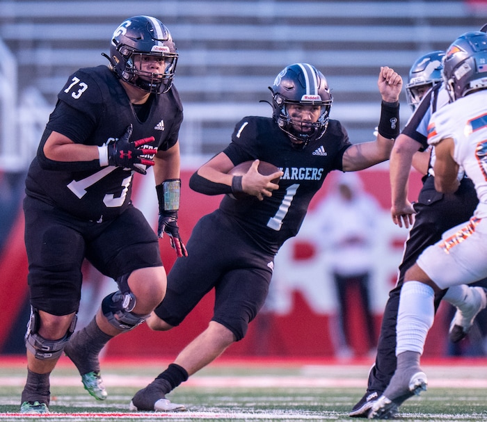 (Rick Egan | The Salt Lake Tribune) Corner Canyon QB Isaac Wilson (1), runs for a touchdown, in the Chargers 6A State championship win over the Skyridge Falcons, at Rice-Eccles Stadium, on Friday, Nov. 17, 2023.