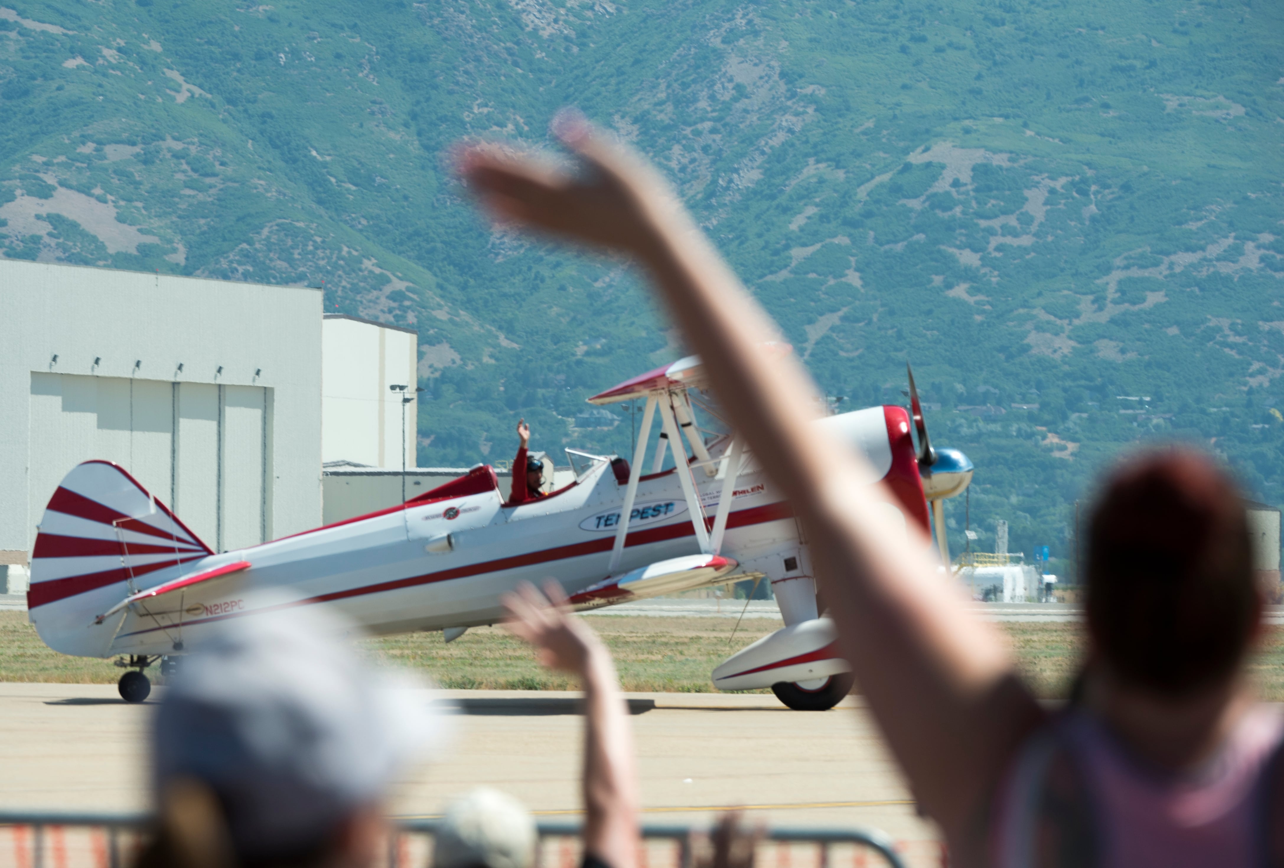 (Rick Egan | The Salt Lake Tribune) Gary Rower waves to the crowd as he lands in his 1941 Stearman, at the Warriors Over the Wasatch airs how at Hill Air Force Base on Sunday, June 24, 2018.
