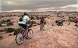 (Al Hartmann | Tribune file photo) A group of mountain bikers negotiate the practice loop on the slick rock trail near Moab, April 20, 2001.