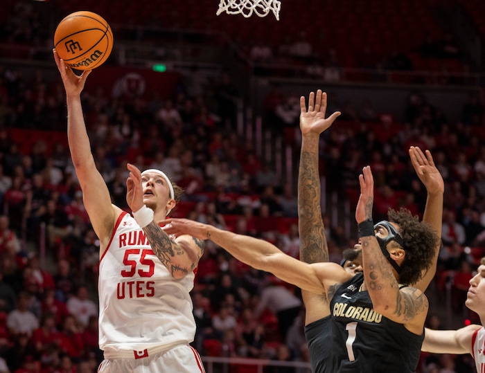 (Rick Egan | The Salt Lake Tribune) Utah Utes guard Gabe Madsen (55) shoots as Colorado Buffaloes guard J'Vonne Hadley (1) defends, in PAC-12 basketball action between the Utah Utes and the Colorado Buffaloes a the Jon M. Huntsman Center, on Saturday, Feb. 3, 2024.
