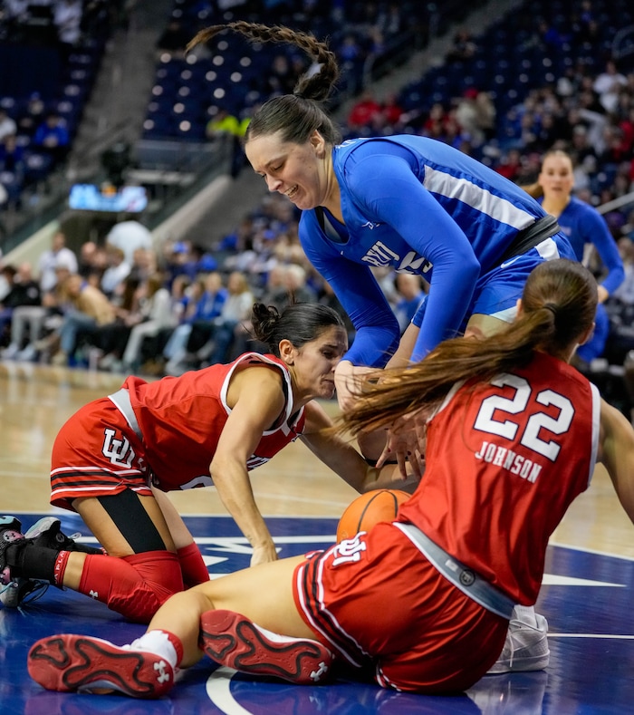 (Francisco Kjolseth  | The Salt Lake Tribune) Utah Utes guard Ines Vieira (2) and Utah Utes forward Jenna Johnson (22) tumble with BYU Cougars forward Emma Calvert (25)  as BYU hosts Utah, NCAA basketball in Provo on Saturday, Jan. 25, 2025.