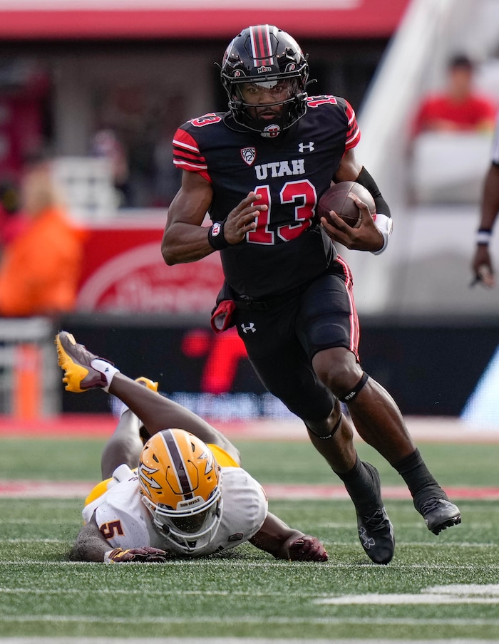 (Francisco Kjolseth  |  The Salt Lake Tribune) Utah Utes quarterback Nate Johnson (13) eludes Arizona State Sun Devils defensive back Chris Edmonds (5) for a 59-yard touchdown run in Salt Lake City on Saturday, Nov. 4, 2023.