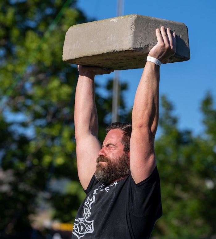 (Rick Egan | The Salt Lake Tribune)  Larson Quick competes in the Stone Press event in the Utah Stones of Strength Strongman competition at the Utah Scottish Festival, at the Utah State Fairpark, on Friday, June 16, 2023.
