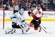 Utah Hockey Club goaltender Jaxson Stauber, left, looks to block a shot past the screen of Philadelphia Flyers' Morgan Frost (48) during the second period of an NHL hockey game, Sunday, Dec. 8, 2024, in Philadelphia. (AP Photo/Derik Hamilton)