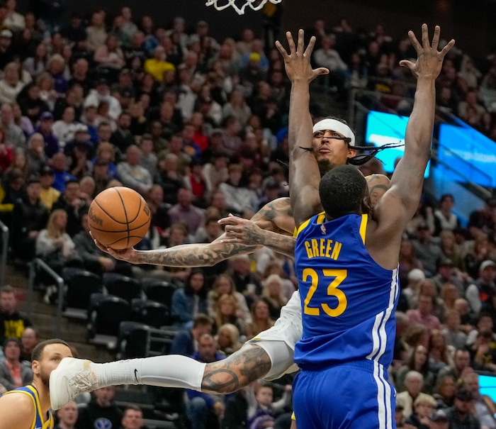 (Francisco Kjolseth  |  The Salt Lake Tribune) Utah Jazz guard Jordan Clarkson (00) redirects the ball past Golden State Warriors forward Draymond Green (23) during an NBA basketball game Thursday, Feb. 15, 2024, in Salt Lake City.