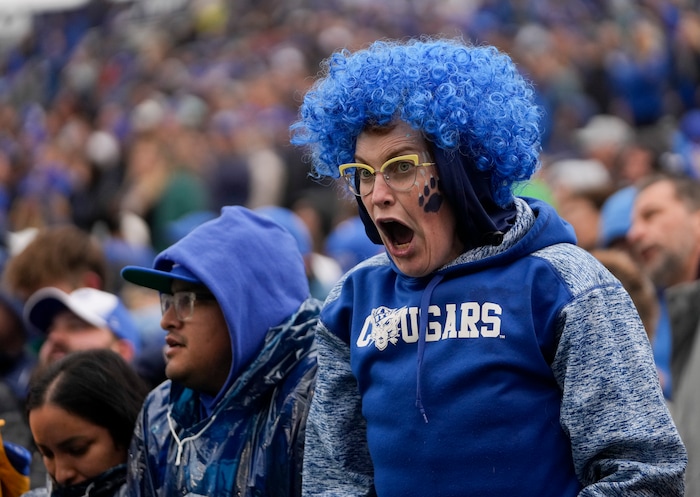 (Bethany Baker  |  The Salt Lake Tribune) A Brigham Young Cougars fan cheers during the game against the Oklahoma Sooners at LaVell Edwards Stadium in Provo on Saturday, Nov. 18, 2023.