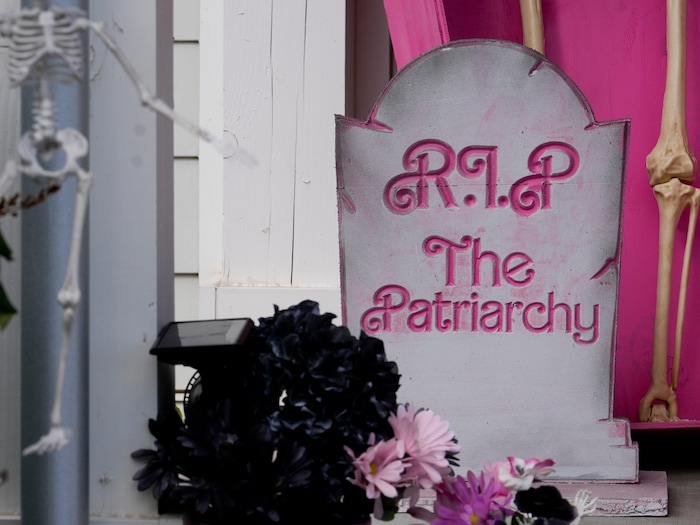 (Bethany Baker  |  The Salt Lake Tribune) A tombstone reads “R.I.P. The Patriarchy” on the porch of a home in a section of Daybreak that has collectively created a Barbieland-themed community for Halloween on Wednesday, Oct. 11, 2023.