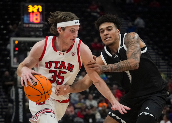 (Bethany Baker  |  The Salt Lake Tribune) Utah Utes center Branden Carlson (35) drives to the basket as Hawaii Warriors forward Justin McKoy (1) defends at the Delta Center in Salt Lake City on Thursday, Nov. 30, 2023.