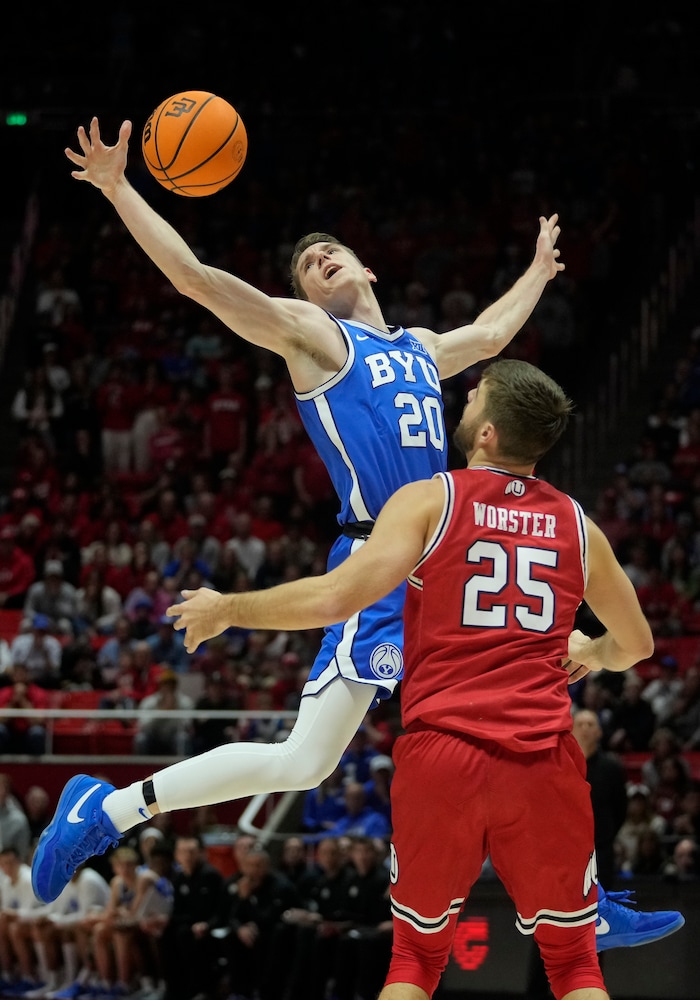 (Bethany Baker  |  The Salt Lake Tribune) Brigham Young Cougars guard Spencer Johnson (20) loses control of the ball as Utah Utes guard Rollie Worster (25) defends at the Jon M. Huntsman Center in Salt Lake City on Saturday, Dec. 9, 2023.