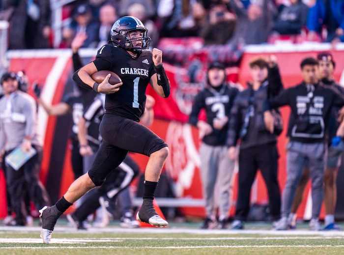 (Rick Egan | The Salt Lake Tribune) Corner Canyon QB Isaac Wilson (1), runs for a touchdown, in the Chargers 6A State championship win over the Skyridge Falcons, at Rice-Eccles Stadium, on Friday, Nov. 17, 2023.