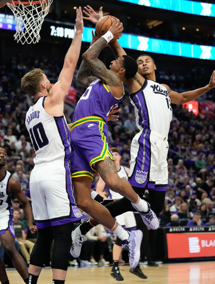 (Francisco Kjolseth  |  The Salt Lake Tribune) Utah Jazz forward John Collins (20) gets blocked by Sacramento Kings forward Domantas Sabonis (10) and Sacramento Kings forward Keegan Murray (13)  as the Utah Jazz host the Sacramento Kings, during NBA basketball in Salt Lake City on Wednesday, Oct. 25, 2023.