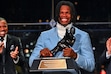 Colorado’s Travis Hunter holds the trophy after winning the Heisman Trophy as the outstanding player in college football, Saturday, Dec. 14, 2024, in New York. (Todd Van Emst/Heisman Trust via AP, Pool)