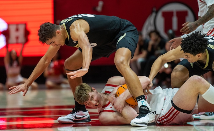 (Rick Egan | The Salt Lake Tribune) Utah Utes center Lawson Lovering (34) grabs the ball, as Colorado Buffaloes forward Tristan da Silva (23) and Colorado Buffaloes guard KJ Simpson (2) defend, in PAC-12 basketball action between the Utah Utes and the Colorado Buffaloes a the Jon M. Huntsman Center, on Saturday, Feb. 3, 2024.
