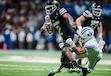 (Jaren Wilkey | BYU) BYU safety Raider Damuni wraps up Colorado quarterback Shedeur Sanders during the 2024 Alamo Bowl in San Antonio.