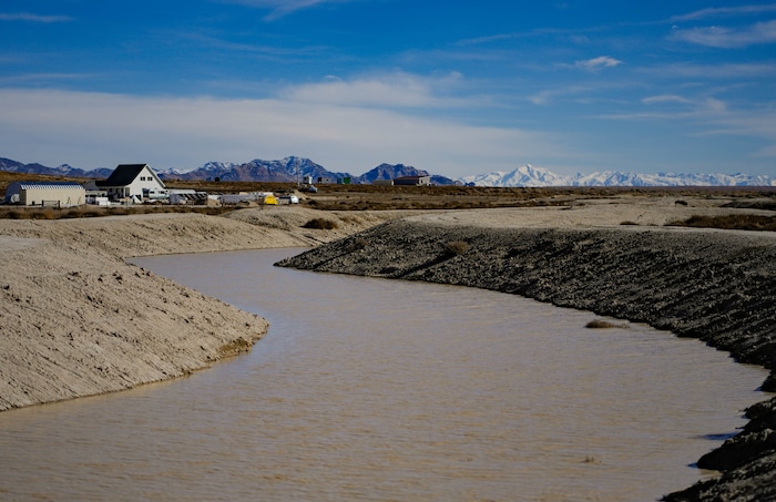 (Francisco Kjolseth  |  The Salt Lake Tribune) A storm water drainage canal marks the low point of Riverbed Ranch in the western Utah desert on Saturday, Feb. 17, 2024. Founder Philip Gleason would like to monetize the unique feature by hosting endurance mud runs or mud bog vehicle racing.