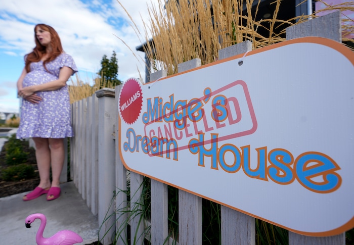 (Bethany Baker  |  The Salt Lake Tribune) Amy Williams, dressed as “Midge” from the movie “Barbie,” stands outside her decorated home in a section of Daybreak that has collectively created a Barbieland-themed community for Halloween on Wednesday, Oct. 11, 2023.