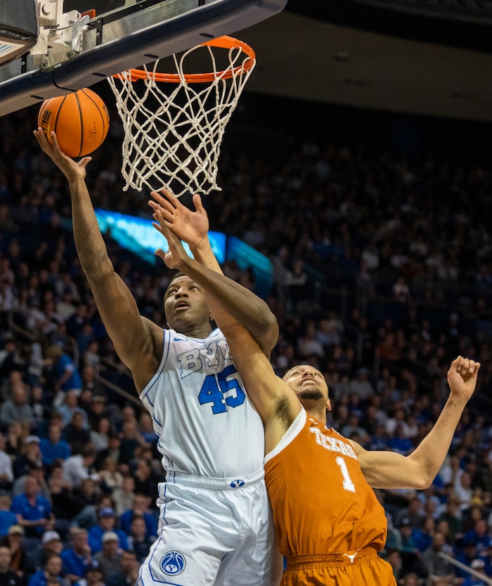 (Rick Egan | The Salt Lake Tribune) Brigham Young Cougars forward Fousseyni Traore (45) goes in for a layup, as Texas Longhorns forward Dylan Disu (1) defends, in basketball action between the Brigham Young Cougars and the Texas Longhorns, at the Marriott Center, on Saturday, Jan. 27, 2024.
