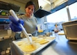 (Bethany Baker  |  The Salt Lake Tribune) Owner Flor Farr wipes an egg wash onto ground beef empanadas at her restaurant Empanada Co. in Salt Lake City on Tuesday, Jan. 14, 2025.