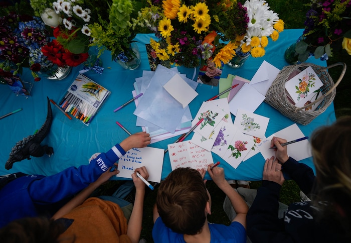 (Francisco Kjolseth  |  The Salt Lake Tribune) People write notes during a memorial at Laird Park in Salt Lake City on Wednesday, May 22, 2024, to honor Adlai Owen. Police say Adlai’s father, Sam Owen, fatally shot Adlai before killing himself in an apparent murder-suicide on Saturday, May 18, 2024.