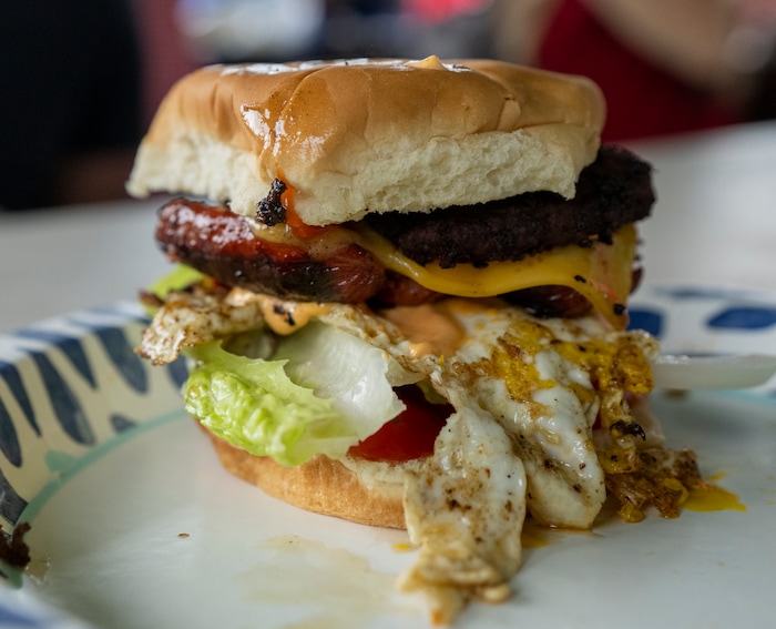 (Rick Egan | The Salt Lake Tribune)  The "Liberty Burger", a hamburger patty with a hotdog, egg, bacon and cheese, with Liberty Days sauce, on a toasted bun, at the Liberty Days celebration in Liberty, Utah, on Tuesday, July 4, 2023.