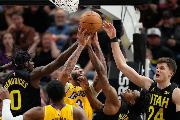 (Francisco Kjolseth  |  The Salt Lake Tribune) Los Angeles Lakers forward Anthony Davis (3) battles for a rebound against Utah Jazz forward Taylor Hendricks (0), Utah Jazz guard Collin Sexton (2) and Utah Jazz center Walker Kessler (24) during an NBA basketball game Wednesday, Feb. 14, 2024, in Salt Lake City.