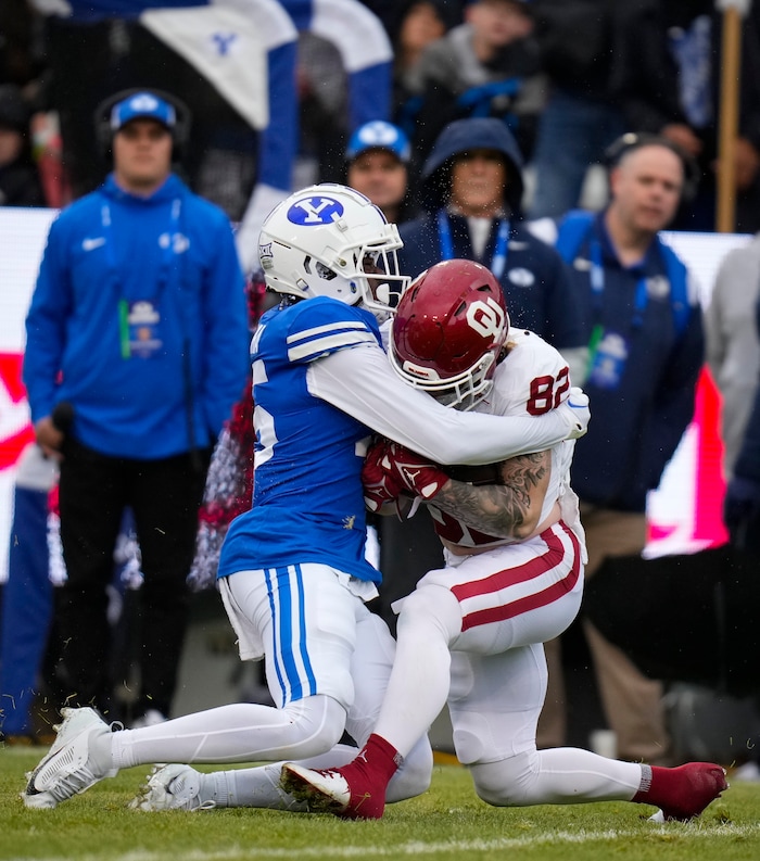 (Bethany Baker  |  The Salt Lake Tribune) Brigham Young Cougars safety Chika Ebunoha (15) tackles Oklahoma Sooners wide receiver Gavin Freeman (82) at LaVell Edwards Stadium in Provo on Saturday, Nov. 18, 2023.