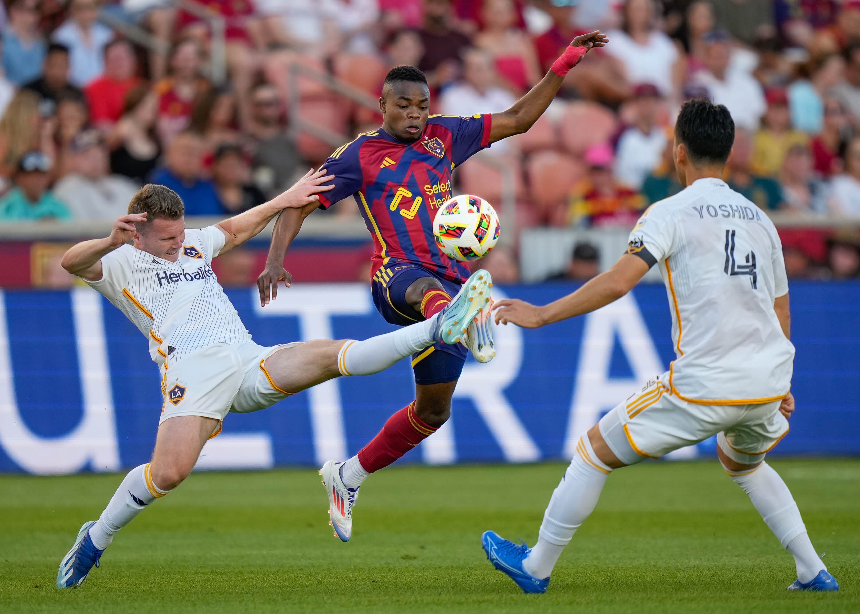 (Francisco Kjolseth | The Salt Lake Tribune) Real Salt Lake forward Carlos Andrés Gómez (11) goes between Los Angeles Galaxy defender John Nelson (14) and Los Angeles Galaxy defender Maya Yoshida (4) in game action during an MLS soccer match against LA Galaxy on Saturday, June 22, 2024, in Sandy Utah.