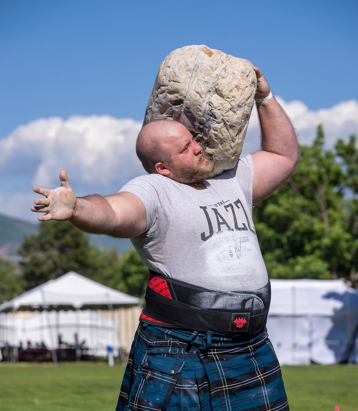 (Rick Egan | The Salt Lake Tribune)  Richard Peterson competes in the Max Stone to Shoulder event in the Utah Stones of Strength Strongman competition at the Utah Scottish Festival, at the Utah State Fairpark, on Friday, June 16, 2023.
