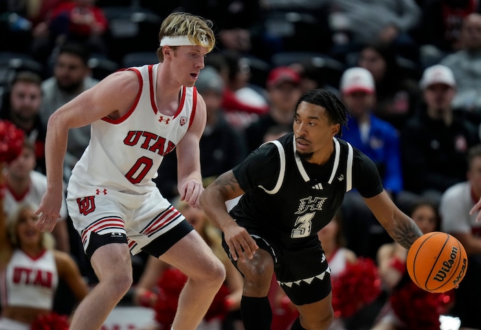 (Bethany Baker  |  The Salt Lake Tribune) Utah Utes guard Hunter Erickson (0) defends as Hawaii Warriors guard JoVon McClanahan (3) moves the ball at the Delta Center in Salt Lake City on Thursday, Nov. 30, 2023.
