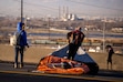 (Rick Egan | The Salt Lake Tribune) Homeless people drag their belongings across Victory Road as authorities clear an encampment in the area on Thursday, December 14, 2023. Utah's first ever homeless mortality report found unsheltered people are dying at 10 times the rate of housed people.