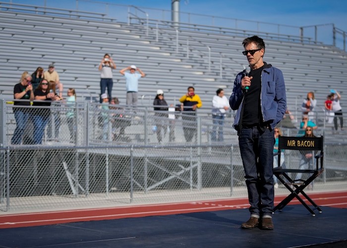 (Bethany Baker  |  The Salt Lake Tribune) Kevin Bacon speaks at a charity event to commemorate the 40th anniversary of the movie "Footloose" on the football field of Payson High School in Payson on Saturday, April 20, 2024.