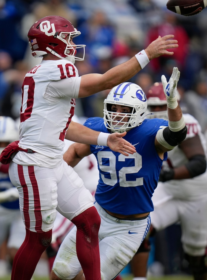 (Bethany Baker  |  The Salt Lake Tribune) Brigham Young Cougars defensive end Tyler Batty (92) attempts to block a pass from Oklahoma Sooners quarterback Jackson Arnold (10) at LaVell Edwards Stadium in Provo on Saturday, Nov. 18, 2023.