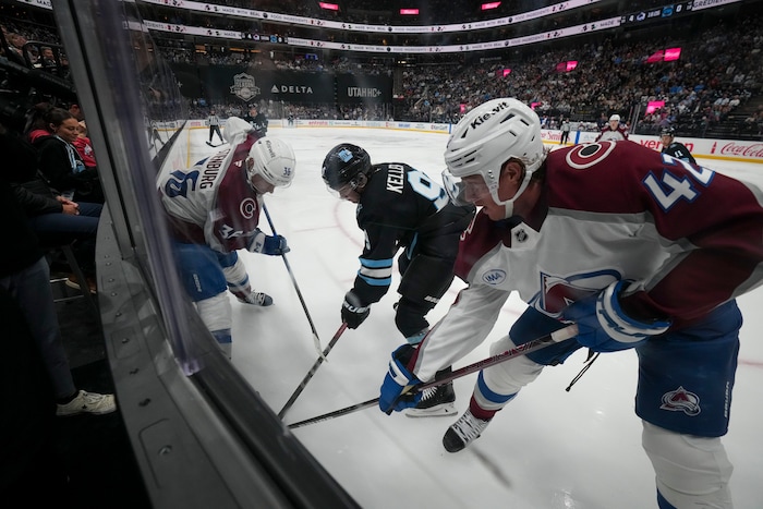 (Bethany Baker  |  The Salt Lake Tribune) Utah Hockey Club center Clayton Keller (9) vies for the puck with Colorado Avalanche defenseman Josh Manson (42) and Colorado Avalanche center Matt Stienburg (36) during the game between the Utah Hockey Club and the Colorado Avalanche at the Delta Center in Salt Lake City on Thursday, Oct. 24, 2024.