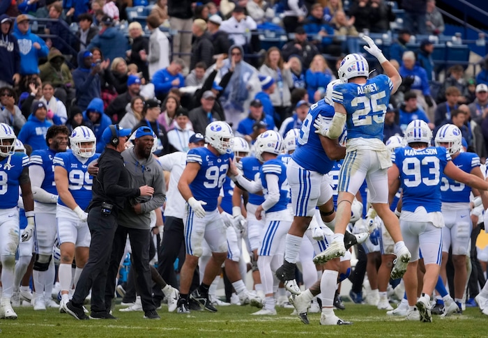 (Bethany Baker  |  The Salt Lake Tribune) Brigham Young Cougars celebrate a turnover against the Oklahoma Sooners at LaVell Edwards Stadium in Provo on Saturday, Nov. 18, 2023.