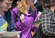 (Chris Samuels | The Salt Lake Tribune) Students leaving Granger High School in West Valley City unlock their cell phones after exiting the school’s doors, Monday, Aug. 26, 2024.