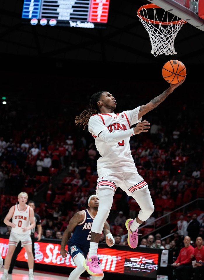 (Francisco Kjolseth  |  The Salt Lake Tribune) Utah Utes guard Deivon Smith (5) sails one in during PAC-12 basketball action between the Utah Utes and the Arizona Wildcats at the Jon M. Huntsman Center, on Thursday, Feb. 8, 2024.