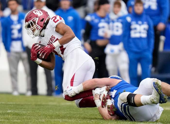 (Bethany Baker  |  The Salt Lake Tribune) Brigham Young Cougars defensive tackle Jackson Cravens (91) tackles Oklahoma Sooners running back Gavin Sawchuk (27) at LaVell Edwards Stadium in Provo on Saturday, Nov. 18, 2023.