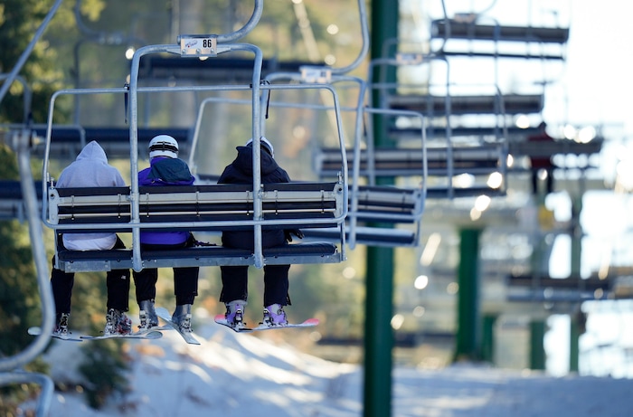 (Bethany Baker  |  The Salt Lake Tribune) Three skiers ride the lift at Sundance Resort near Provo on Thursday, Dec. 14, 2023.