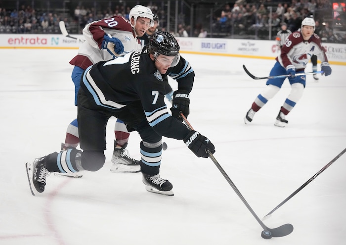 (Bethany Baker  |  The Salt Lake Tribune) Utah Hockey Club defenseman Michael Kesselring (7) fights for the puck during the game between the Utah Hockey Club and the Colorado Avalanche at the Delta Center in Salt Lake City on Thursday, Oct. 24, 2024.