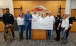 (Michael Cook) Ivins Mayor Chris Hart, third from left, holds a check with Defenders of Greater Ivins member Michael Book for a donation to pay for a police K-9.