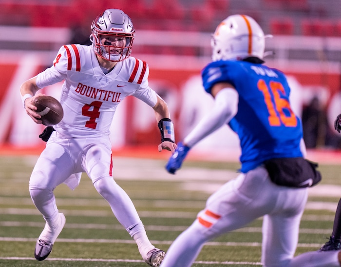 (Rick Egan | The Salt Lake Tribune)   Bountiful quarterback Emerson Geilman runs for the Redhawks, as Nelesoni Tuua defends for Timpview, in 5A State playoff action between the Timpview Thunderbirds and the Bountiful Redhawks, at Rice-Eccles Stadium, on Friday, Nov. 17, 2023.
